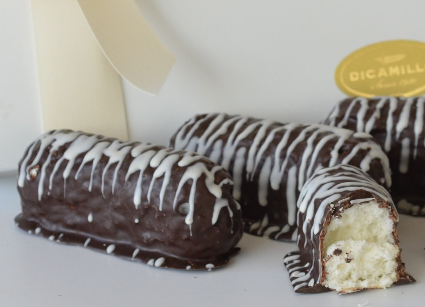 CHOCOLATE COVERED ANGEL FOOD FINGER CAKES WITH WHITE DRIZZLE